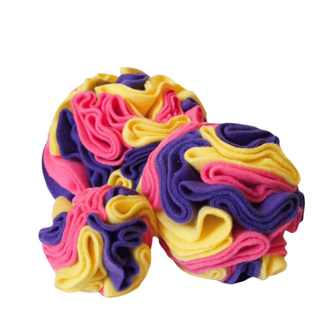 Small, medium and large snuffle balls in colour way Bloom - yellow, pink and purple. Enrichment toy for pets handmade in New Zealand.